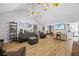 Open living space with vaulted ceilings, a rock fireplace, hardwood flooring, and neutral decor at 4030 Grady Smith Road Rd, Loganville, GA 30052