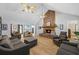 Living area features a stone fireplace, vaulted ceiling, hardwood floors and comfortable seating at 4030 Grady Smith Road Rd, Loganville, GA 30052