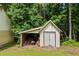 Rustic outbuilding perfect for storage, featuring a durable structure and convenient access in a wooded area at 4030 Grady Smith Road Rd, Loganville, GA 30052