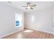Neutral bedroom featuring light wood floors, a ceiling fan, and bright windows at 3286 Bachelor Street, East Point, GA 30344
