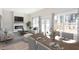 Open concept living space featuring modern decor, a fireplace, and dining area with a large table at 3286 Bachelor Street, East Point, GA 30344