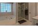 Bright bathroom features a separate tub and shower with decorative tile and ample natural light at 5176 Ashbury Manor Ln, Sugar Hill, GA 30518