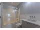 Clean bathroom featuring a shower over the tub and a vanity with light gray cabinetry at 5176 Ashbury Manor Ln, Sugar Hill, GA 30518