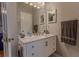 Elegant bathroom boasts a marble vanity, neutral paint colors, and bright lighting at 5176 Ashbury Manor Ln, Sugar Hill, GA 30518