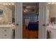 Spacious primary bedroom featuring hardwood floors, tray ceilings, and ensuite with marble vanity at 5176 Ashbury Manor Ln, Sugar Hill, GA 30518