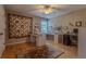 Multi-purpose bonus room featuring wood flooring, built-in desk, and bright natural light at 5176 Ashbury Manor Ln, Sugar Hill, GA 30518