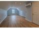 Spacious bonus room featuring light-colored walls, wood floors, and a window for ample natural light at 5176 Ashbury Manor Ln, Sugar Hill, GA 30518