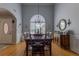 Bright dining room with hardwood floors, a large window, and classic chandelier, perfect for entertaining at 5176 Ashbury Manor Ln, Sugar Hill, GA 30518