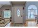 Elegant foyer featuring a decorative front door, natural light, and hardwood floors, creating a welcoming ambiance at 5176 Ashbury Manor Ln, Sugar Hill, GA 30518