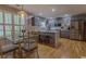 Modern kitchen featuring gray cabinets, stainless steel appliances, and an island with seating at 5176 Ashbury Manor Ln, Sugar Hill, GA 30518