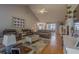Open living room with a vaulted ceiling, hardwood flooring and a brick fireplace at 5176 Ashbury Manor Ln, Sugar Hill, GA 30518