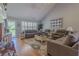 Bright living room with vaulted ceiling and hardwood floors is furnished with couches and lamps at 5176 Ashbury Manor Ln, Sugar Hill, GA 30518