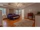 Main bedroom features hardwood floors, tray ceiling, and a large window with great natural light at 5176 Ashbury Manor Ln, Sugar Hill, GA 30518
