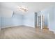Bright bedroom with light wood floors, ceiling fan, and access to multiple rooms at 5430 Breckinridge Ln, Cumming, GA 30040