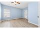 Bright bedroom with hardwood floors, a ceiling fan, and a window overlooking outdoors at 5430 Breckinridge Ln, Cumming, GA 30040
