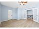 Bedroom featuring hardwood floors, French doors, and staircase access at 5430 Breckinridge Ln, Cumming, GA 30040