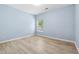 Charming bedroom with hardwood floors, a window providing natural light, and neutral paint at 5430 Breckinridge Ln, Cumming, GA 30040