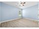 Light-filled bedroom with light hardwood floors, a ceiling fan, and neutral color palette at 5430 Breckinridge Ln, Cumming, GA 30040