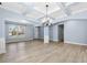 Dining room with hardwood floors, coffered ceiling, and large windows at 5430 Breckinridge Ln, Cumming, GA 30040