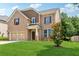 Charming two-story brick home with a manicured lawn and mature tree at 5430 Breckinridge Ln, Cumming, GA 30040