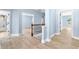 Hallway with wood flooring leads to multiple rooms and bathroom with light blue walls at 5430 Breckinridge Ln, Cumming, GA 30040