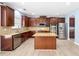 Kitchen features stainless steel appliances, granite counters, and a center island at 5430 Breckinridge Ln, Cumming, GA 30040