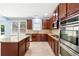 Kitchen features a center island, stainless appliances, and granite countertops at 5430 Breckinridge Ln, Cumming, GA 30040