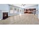 Spacious living room with fireplace, lots of windows, and beautiful hardwood floors open to the kitchen at 5430 Breckinridge Ln, Cumming, GA 30040