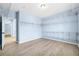 Large walk-in closet with hardwood floors and built-in shelving for optimal storage at 5430 Breckinridge Ln, Cumming, GA 30040