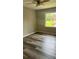 Bedroom with new hardwood flooring, a ceiling fan and view of the front yard at 188 Rue Fontaine, Lithonia, GA 30038
