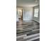 Bright bedroom featuring new plank floors, a bathroom en suite, and a large sun-filled window at 188 Rue Fontaine, Lithonia, GA 30038