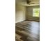 Spacious bedroom featuring a window, ceiling fan and newly installed wood flooring at 188 Rue Fontaine, Lithonia, GA 30038