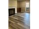 Bright living room with a cozy fireplace and newly installed hardwood flooring at 188 Rue Fontaine, Lithonia, GA 30038