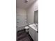 Clean bathroom with tub-shower combination, white vanity, and wood-look flooring at 34 Sonoma Drive, Dallas, GA 30157