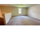 Large bonus room with neutral carpet and a window for natural light at 34 Sonoma Drive, Dallas, GA 30157