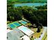 Stunning aerial view of the community's amenities including a pool and tennis courts nestled amongst lush greenery and a lake at 5015 Monticello Dr, Villa Rica, GA 30180