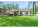 Expansive backyard with a well-kept lawn and a covered patio, ideal for relaxation and outdoor activities at 5015 Monticello Dr, Villa Rica, GA 30180