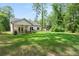 Spacious backyard featuring a well-manicured lawn and a covered patio perfect for outdoor entertaining at 5015 Monticello Dr, Villa Rica, GA 30180