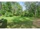 Expansive backyard with lush green grass, mature trees, and a serene setting, offering privacy and space at 5015 Monticello Dr, Villa Rica, GA 30180