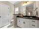 Well-lit bathroom features a modern vanity with black countertops and white cabinetry at 5015 Monticello Dr, Villa Rica, GA 30180