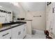 Well-lit bathroom with a marble floor, granite countertop, white cabinetry, and a decorative shower curtain at 5015 Monticello Dr, Villa Rica, GA 30180