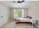 Bright bedroom with a neutral carpet, complemented by a window providing lots of natural light and a ceiling fan at 5015 Monticello Dr, Villa Rica, GA 30180