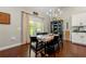 Cozy dining room area featuring a wooden table with black chairs, hardwood floors, and access to an outdoor grill at 5015 Monticello Dr, Villa Rica, GA 30180