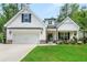 Charming home featuring a well-maintained lawn, stone accents, and an inviting covered front porch at 5015 Monticello Dr, Villa Rica, GA 30180