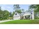 Inviting home boasts a lush lawn, white siding, and a charming covered porch with seating at 5015 Monticello Dr, Villa Rica, GA 30180