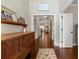 Hallway with dark wood floors, light walls, with decoratively adorned console table at 5015 Monticello Dr, Villa Rica, GA 30180