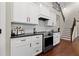 Close up of the kitchen stove with white cabinets and subway tile backsplash at 5015 Monticello Dr, Villa Rica, GA 30180