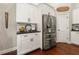 View of the kitchen with stainless steel refrigerator and white cabinets at 5015 Monticello Dr, Villa Rica, GA 30180