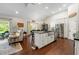Open concept kitchen featuring an island, stainless steel appliances, and seamless access to the living room at 5015 Monticello Dr, Villa Rica, GA 30180
