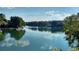 Picturesque lake view showcasing tranquil waters, a beautiful shoreline, and clear blue skies on a sunny day at 5015 Monticello Dr, Villa Rica, GA 30180